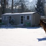 Dog in the snow in front of a mobile home in Gouvieux