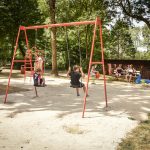 Children having fun in a playground at Camping Pré des moines
