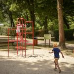 Children having fun in a playground at Camping Pré des moines