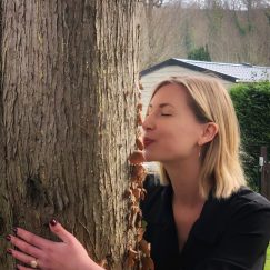 Laura kisses a tree at Camping Pré des moines